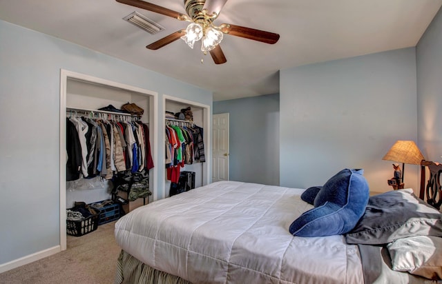 carpeted bedroom featuring baseboards, visible vents, and ceiling fan