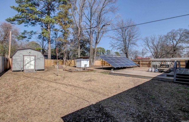 view of yard with a storage unit, an outbuilding, and a fenced backyard