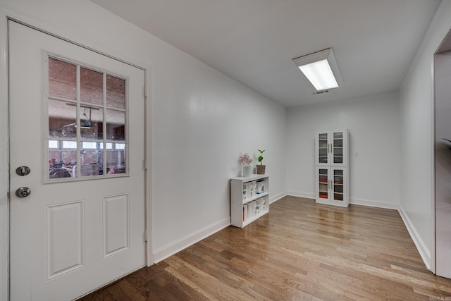 interior space with baseboards and wood finished floors