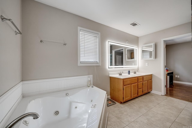 full bath with visible vents, a sink, tile patterned flooring, double vanity, and a whirlpool tub