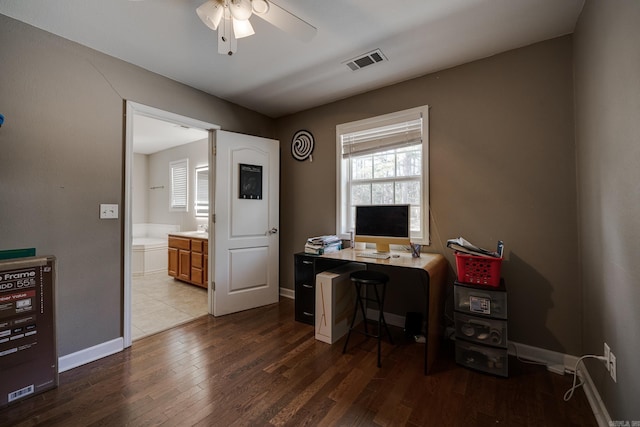 office featuring visible vents, ceiling fan, baseboards, and wood finished floors