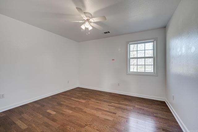 empty room featuring visible vents, baseboards, a ceiling fan, and hardwood / wood-style flooring