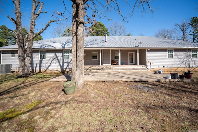 back of property with crawl space, central air condition unit, metal roof, and a patio area