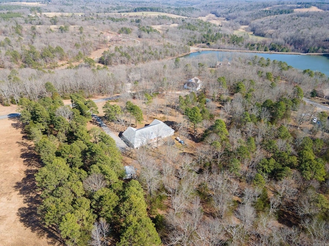 drone / aerial view featuring a forest view and a water view