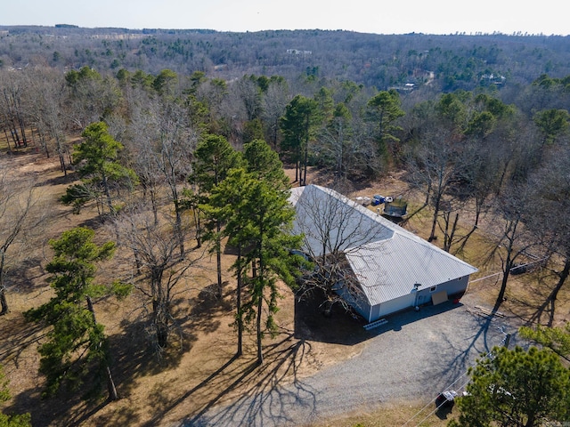 drone / aerial view with a wooded view