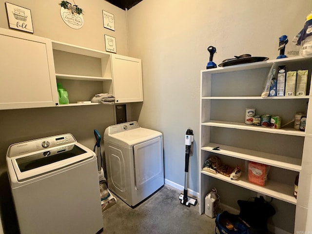 laundry area with washing machine and dryer and cabinet space