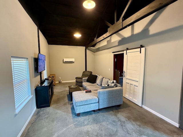 living room featuring a barn door, a wall unit AC, baseboards, and concrete flooring