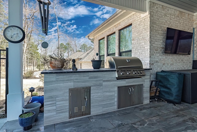 view of patio with area for grilling and grilling area