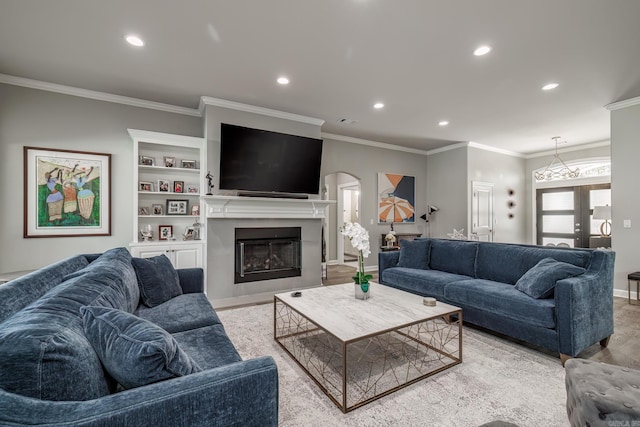 living area with visible vents, baseboards, ornamental molding, recessed lighting, and a fireplace