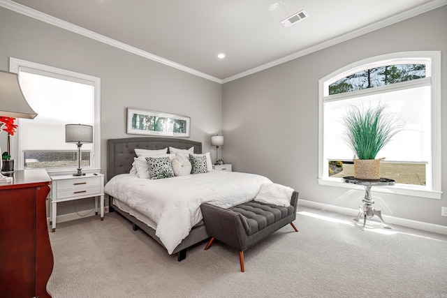 bedroom with visible vents, multiple windows, light colored carpet, and ornamental molding