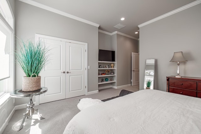 bedroom with visible vents, carpet floors, baseboards, and crown molding