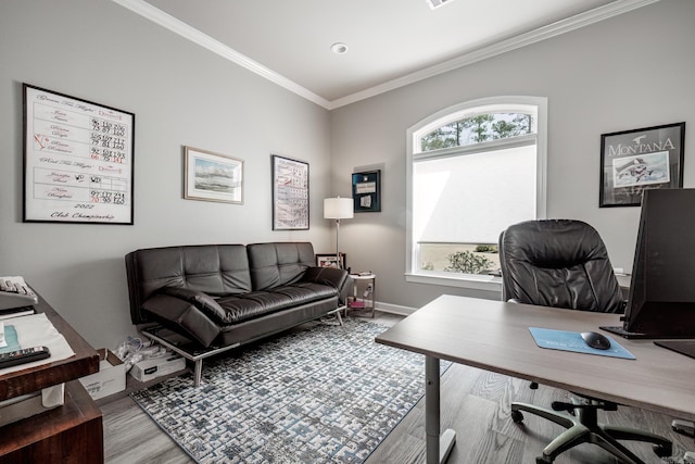 home office with wood finished floors, a healthy amount of sunlight, baseboards, and ornamental molding