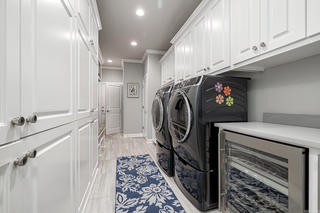 laundry area featuring beverage cooler, washer and clothes dryer, recessed lighting, cabinet space, and crown molding