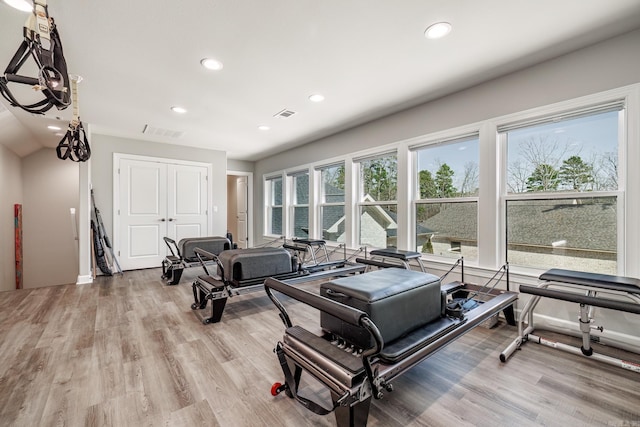 workout area featuring recessed lighting, visible vents, and light wood-style flooring