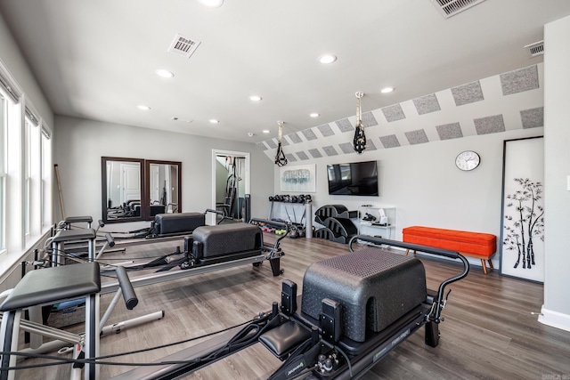 gym with recessed lighting, wood finished floors, and visible vents