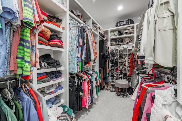 walk in closet with carpet flooring