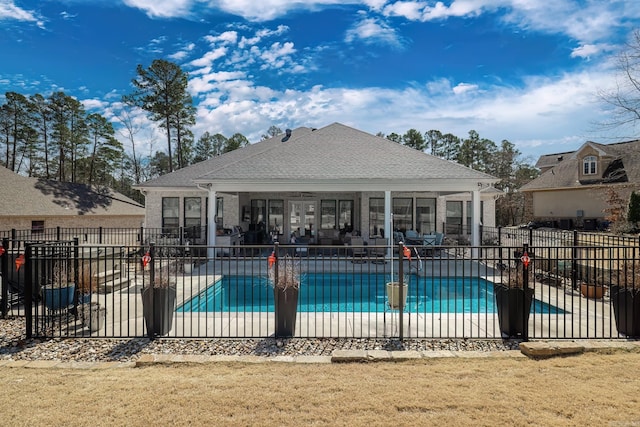 community pool featuring a patio, a yard, and fence