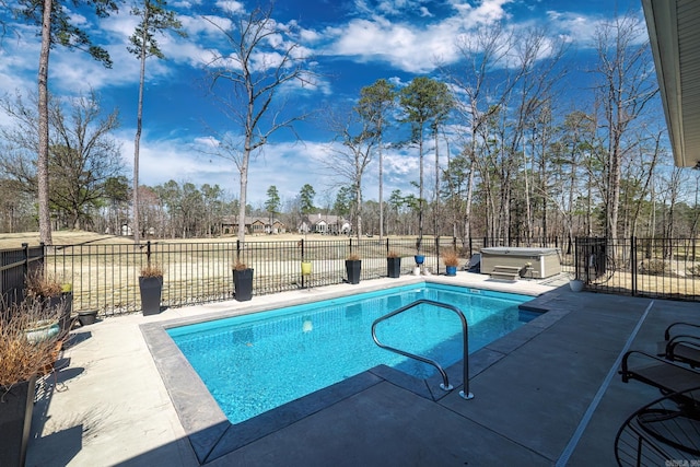 view of swimming pool with a patio, fence, a fenced in pool, and a hot tub