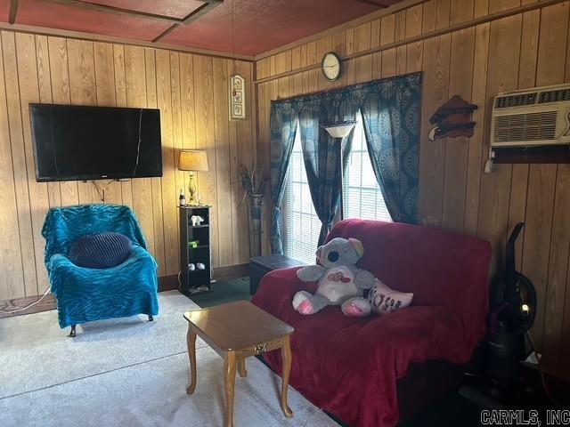 interior space featuring an AC wall unit, wooden walls, and carpet flooring