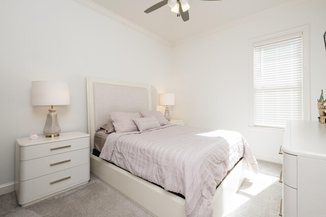 bedroom featuring multiple windows, light carpet, baseboards, and crown molding