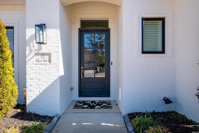 property entrance with brick siding