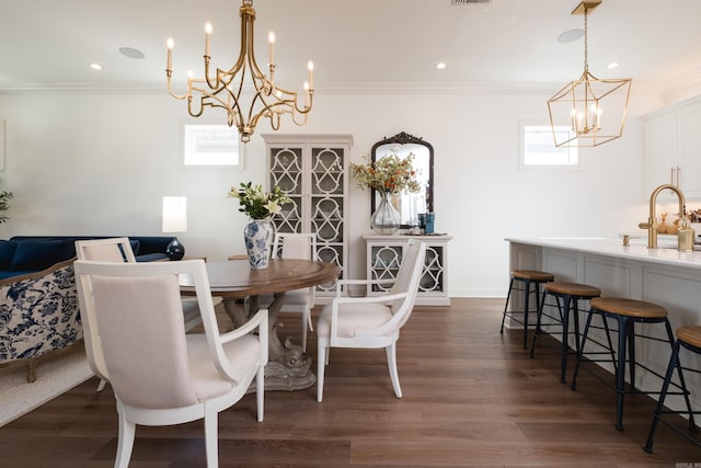 dining room with recessed lighting, a notable chandelier, dark wood finished floors, and crown molding