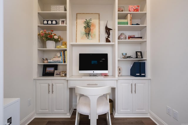 office area with baseboards, dark wood-type flooring, and built in study area