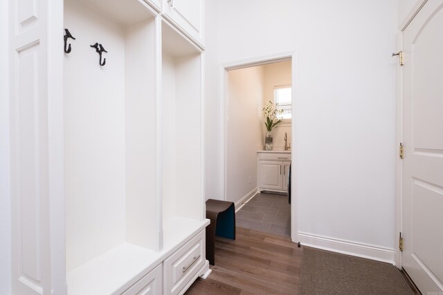 mudroom with baseboards and light wood finished floors