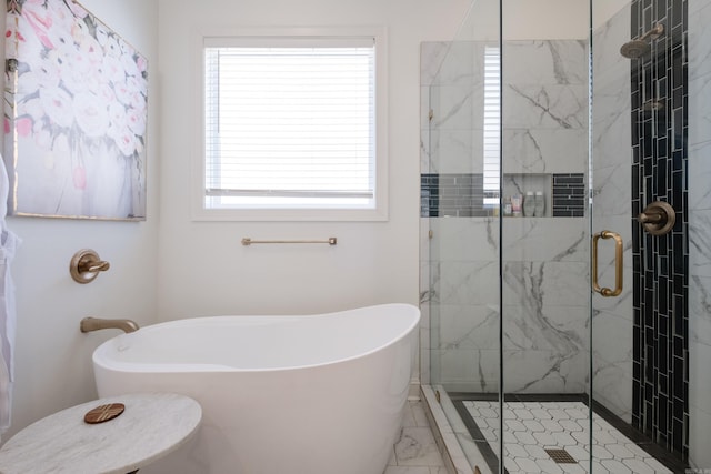 full bath with a shower stall, a freestanding tub, and marble finish floor