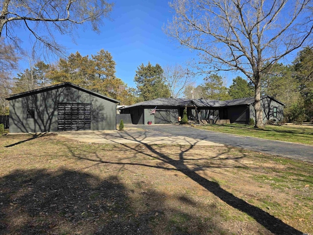 exterior space featuring an outdoor structure and driveway