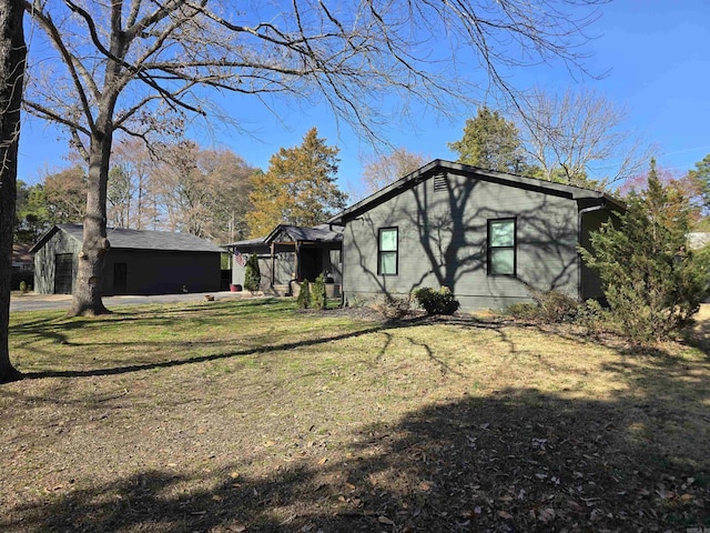 view of home's exterior with an outdoor structure and a lawn