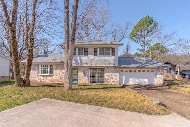 view of front of house with a front lawn, an attached garage, stone siding, and driveway