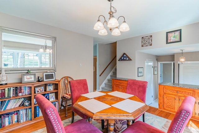 78 Altakima Cir, Cherokee Village, AR 72529 - dining space featuring light wood-type flooring, a notable chandelier, and stairway