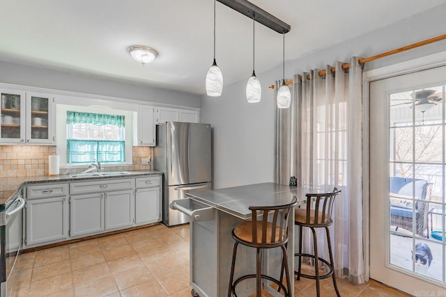 78 Altakima Cir, Cherokee Village, AR 72529 - kitchen featuring backsplash, glass insert cabinets, a breakfast bar, appliances with stainless steel finishes, and a sink