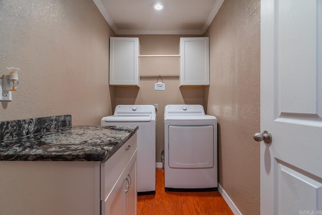 78 Altakima Cir, Cherokee Village, AR 72529 - clothes washing area featuring baseboards, cabinet space, ornamental molding, washer and dryer, and light wood-type flooring