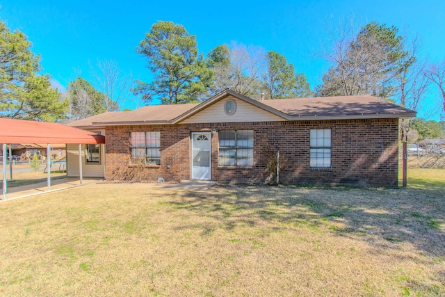 single story home with brick siding, a front yard, and a carport