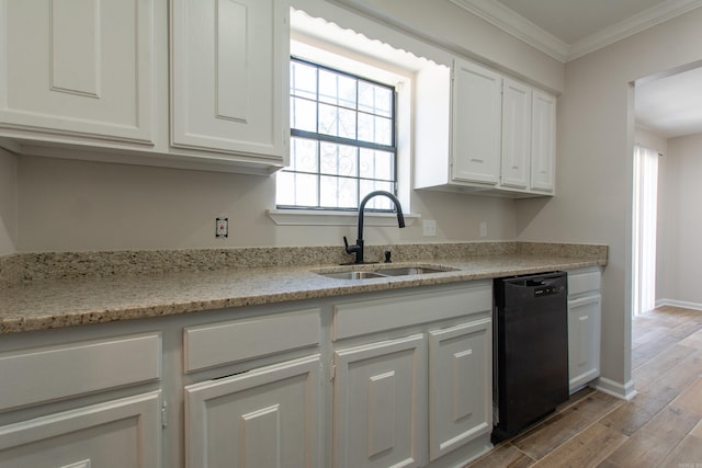 kitchen with light wood-type flooring, a sink, black dishwasher, white cabinets, and crown molding