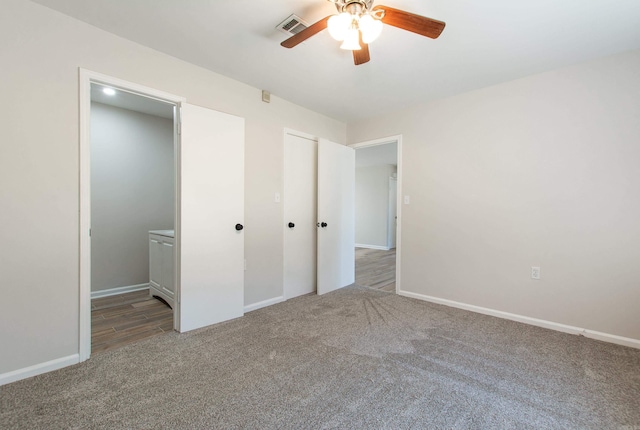 unfurnished bedroom with visible vents, baseboards, and carpet