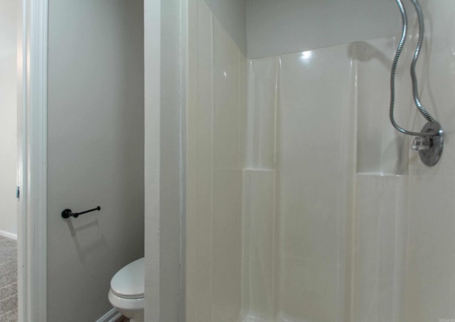 bathroom with a shower and toilet