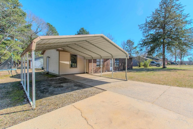 view of parking with a carport, driveway, and a trampoline