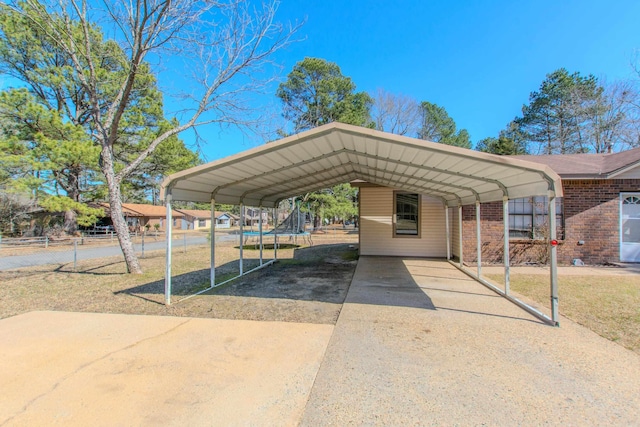 exterior space featuring a carport and fence