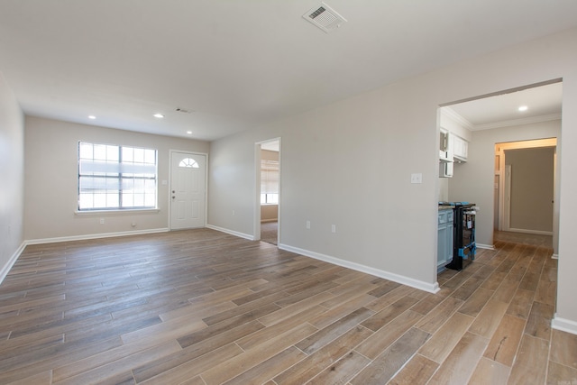 unfurnished living room with light wood-style flooring, recessed lighting, baseboards, and visible vents