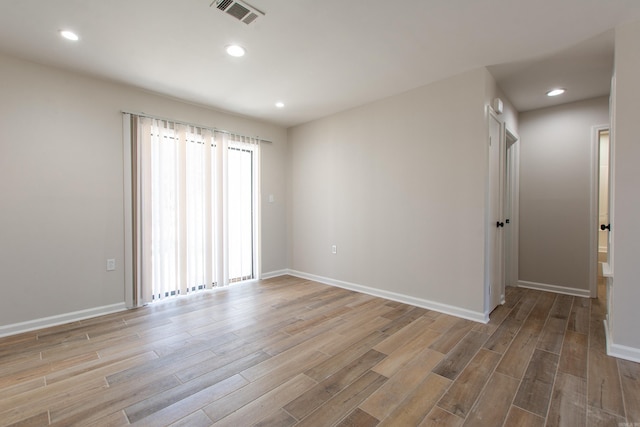 spare room featuring recessed lighting, visible vents, baseboards, and light wood finished floors