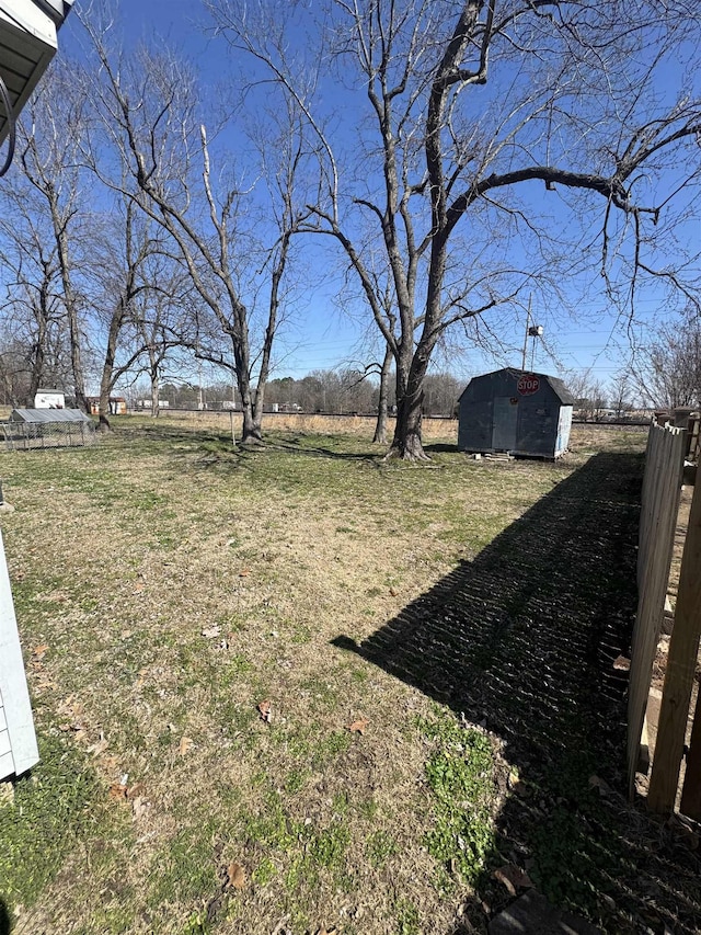 view of yard with an outdoor structure and a shed