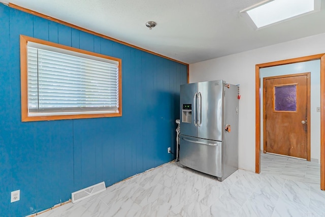 kitchen with visible vents, marble finish floor, and stainless steel refrigerator with ice dispenser