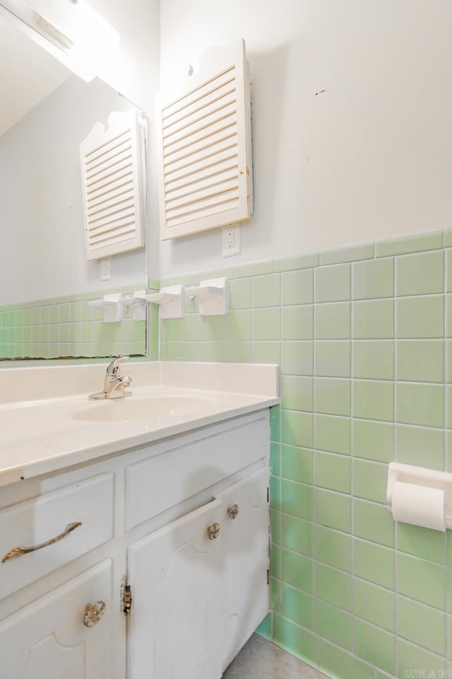 bathroom with vanity, tile walls, and wainscoting