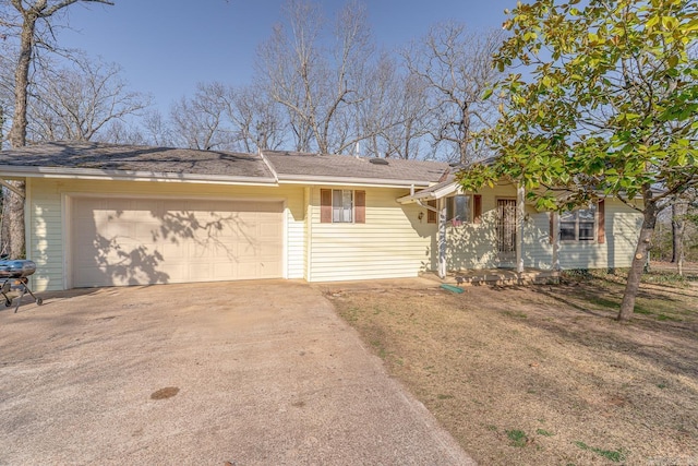 ranch-style home featuring driveway and an attached garage