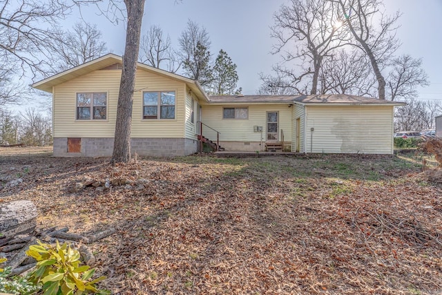 back of property featuring entry steps and crawl space