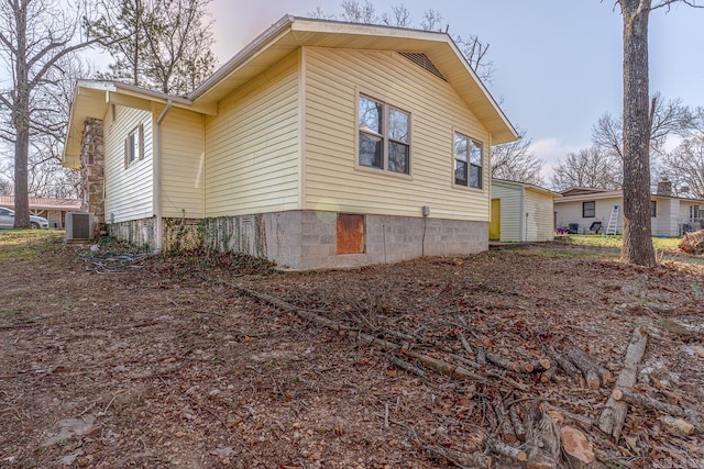 view of side of property featuring central AC