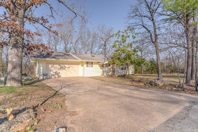 view of front of property featuring concrete driveway and a garage